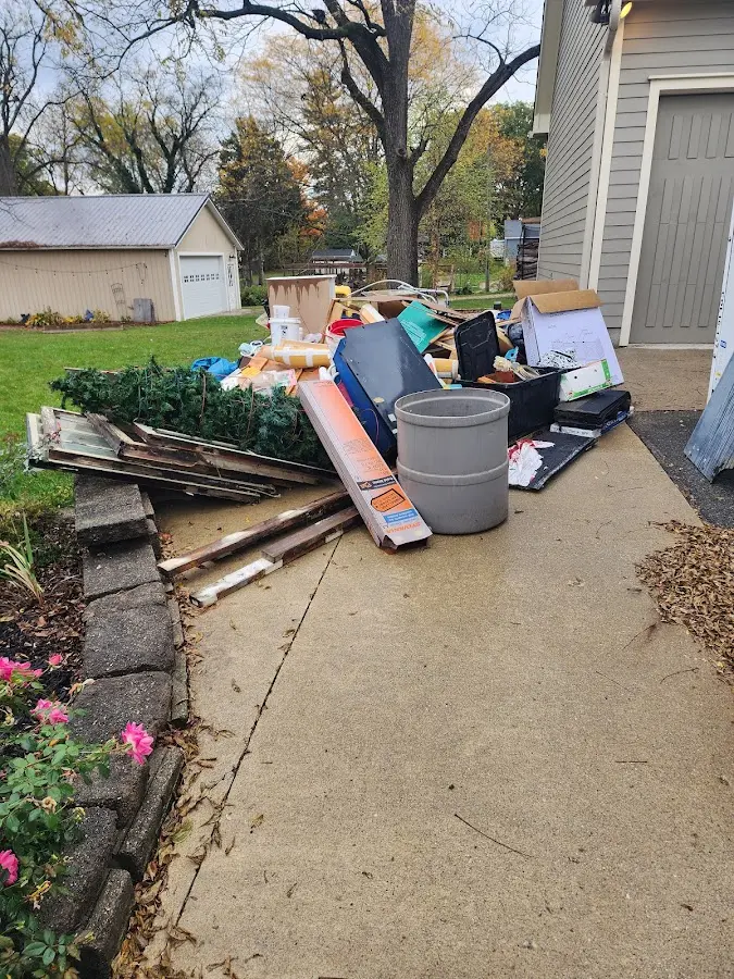 Dumpster being loaded with debris for Estate Cleanout Dumpster Rental in Rochester